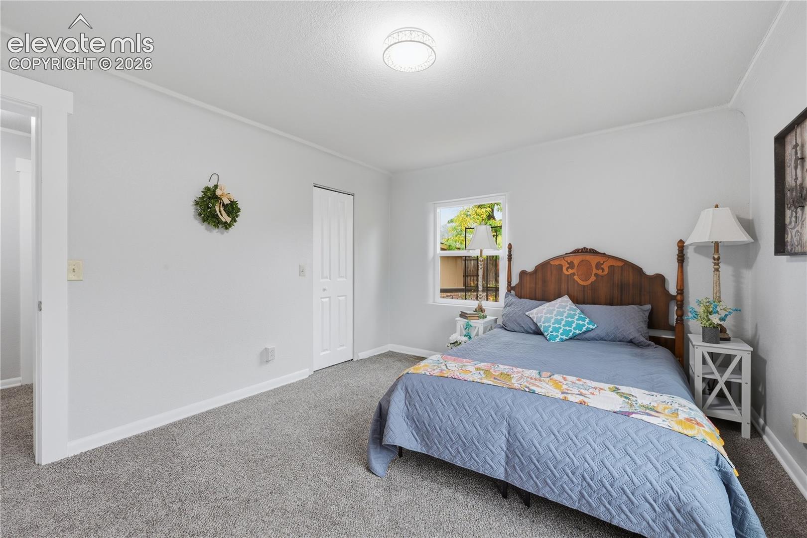 Another view of the primary bedroom. There is walk in closet behind that closet door.