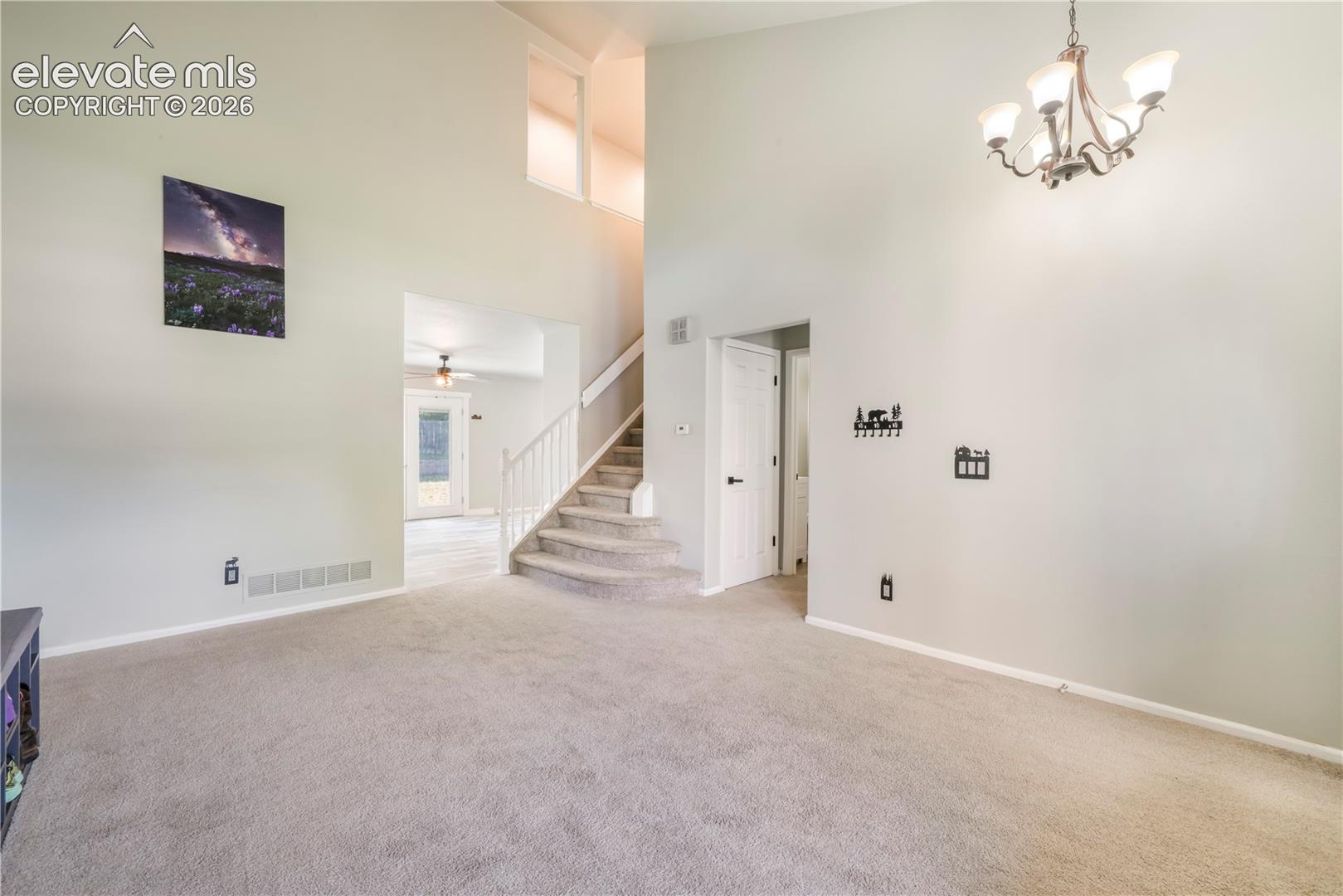 Front formal living room, access to main 1/2 bath, laundry, garage access and views into kitchen