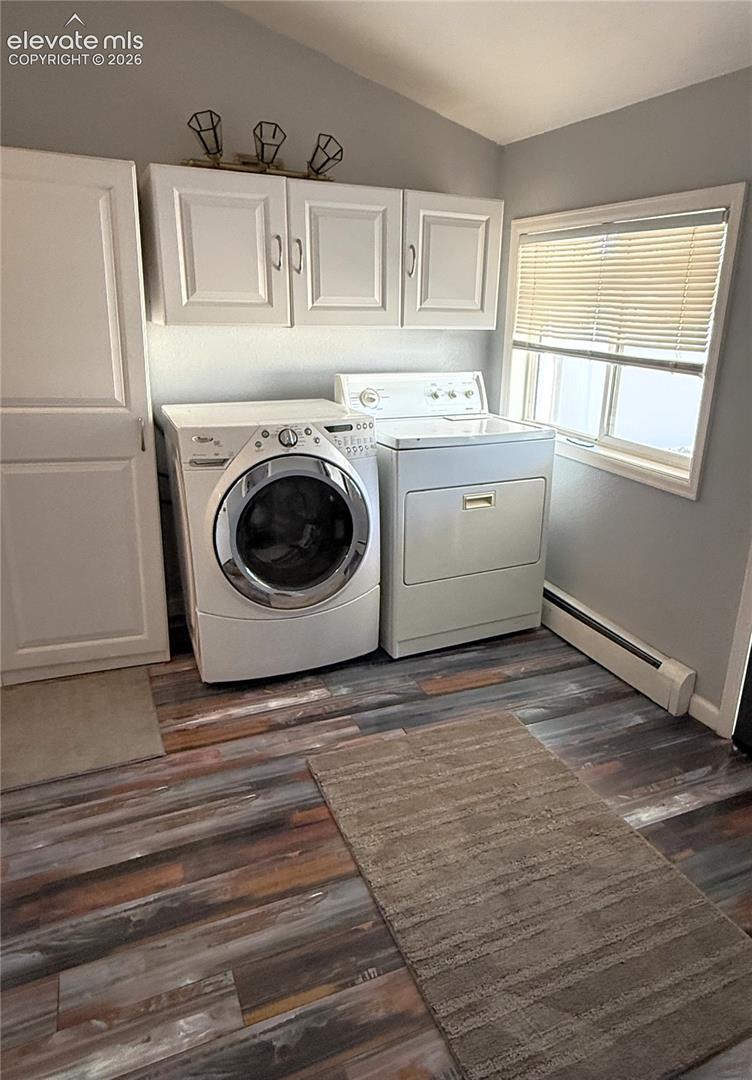 Laundry area featuring wood-finish flooring, white shaker-style cabinetry, a built-in pantry cabinet, and an integrated lighting fixture