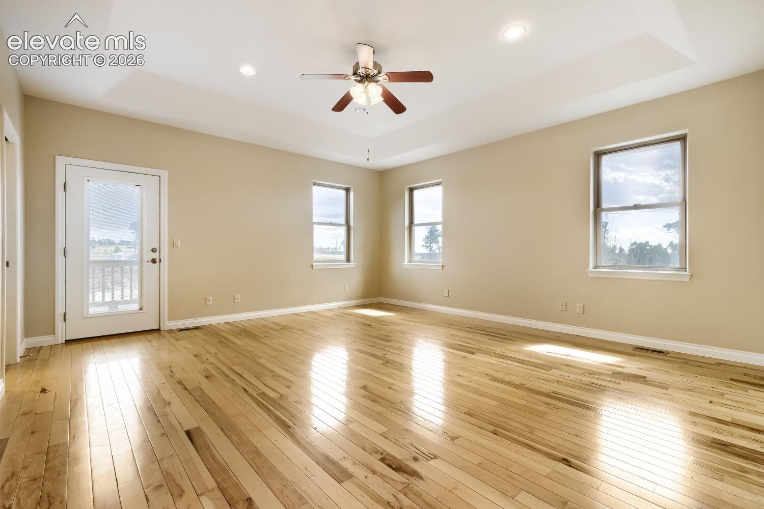 This primary bedroom features a private deck with beautiful long views. 