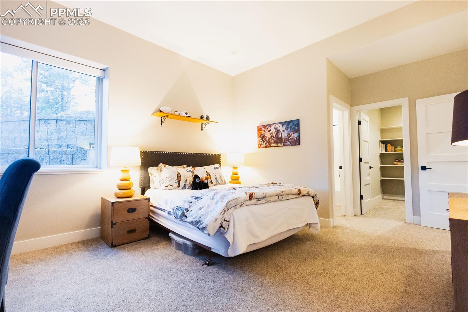 Bedroom featuring light colored carpet and ensuite bathroom