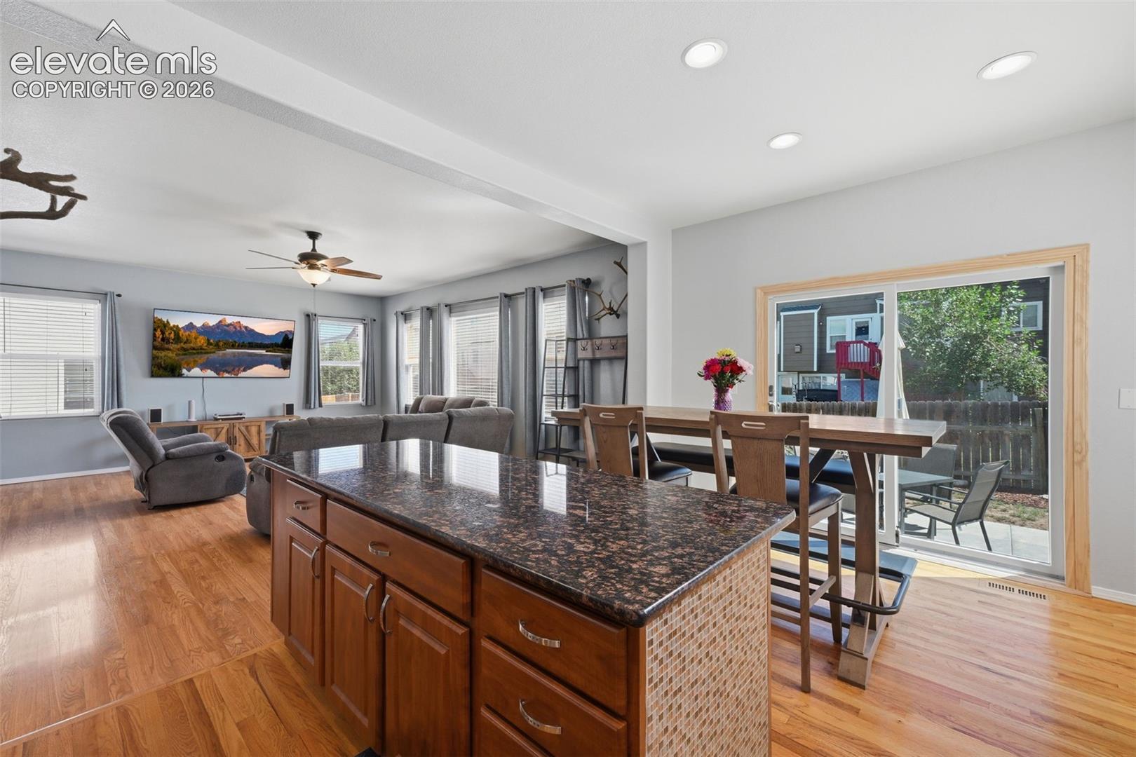 Hardwood flooring, recessed lighting, and a ceiling fan