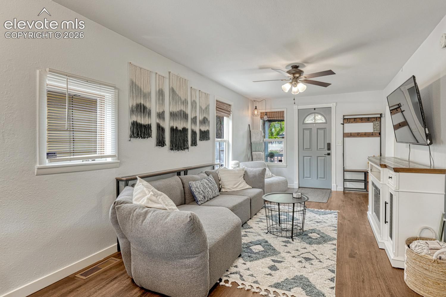 Living space featuring luxury vinyl plankingm white walls, and recessed lighting
