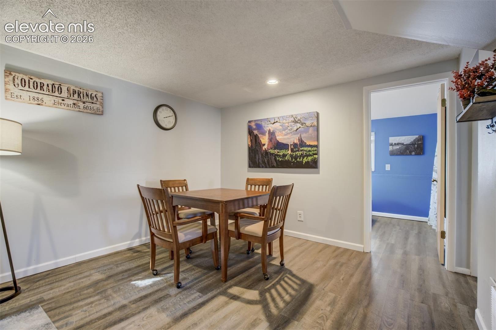 Wood-finish flooring throughout, with white trim and light gray walls