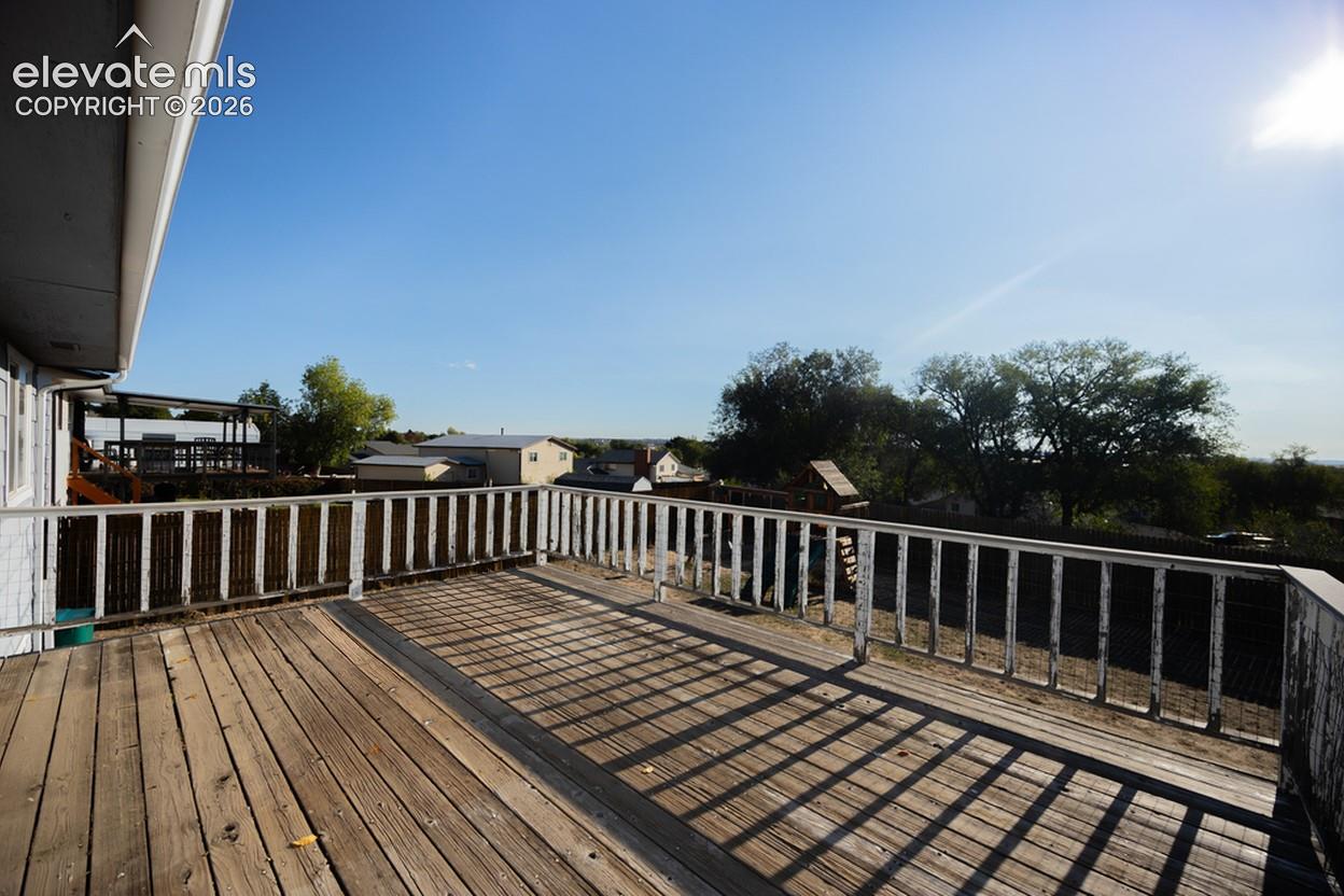 Expansive outdoor deck with wood-finish flooring and railing