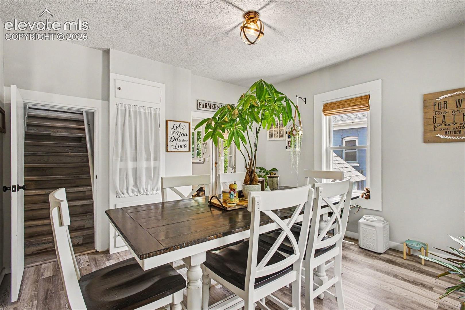 Dining room connects to kitchen, living room, and upstairs bedroom/office and bathroom 