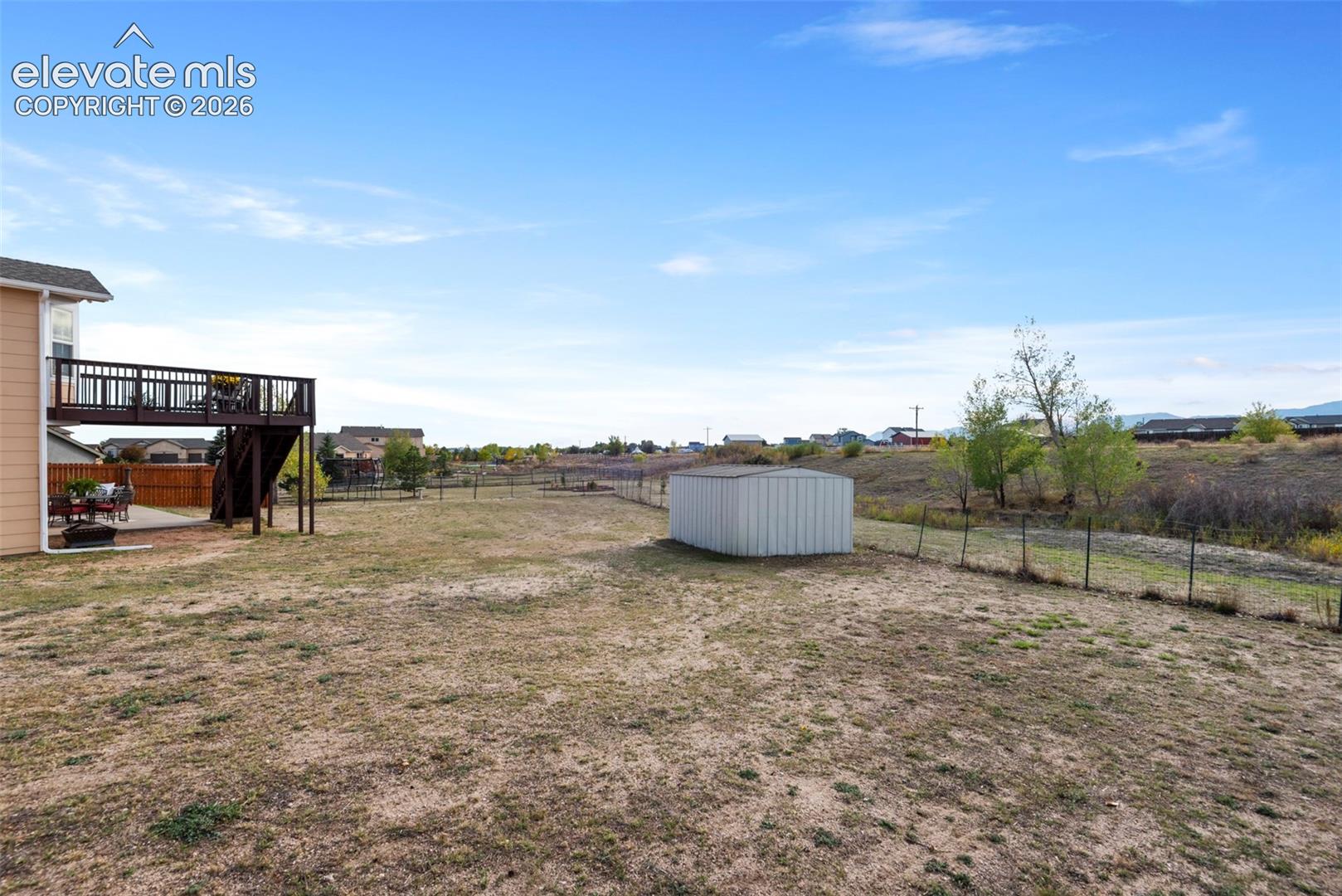 Expansive Backyard, Metal Storage Shed, and Perimeter Fencing