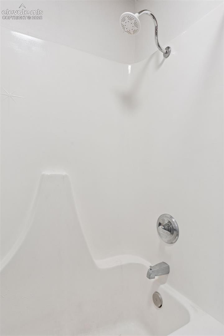 En-suite bathroom shower and tub combination serving the adjacent bedroom