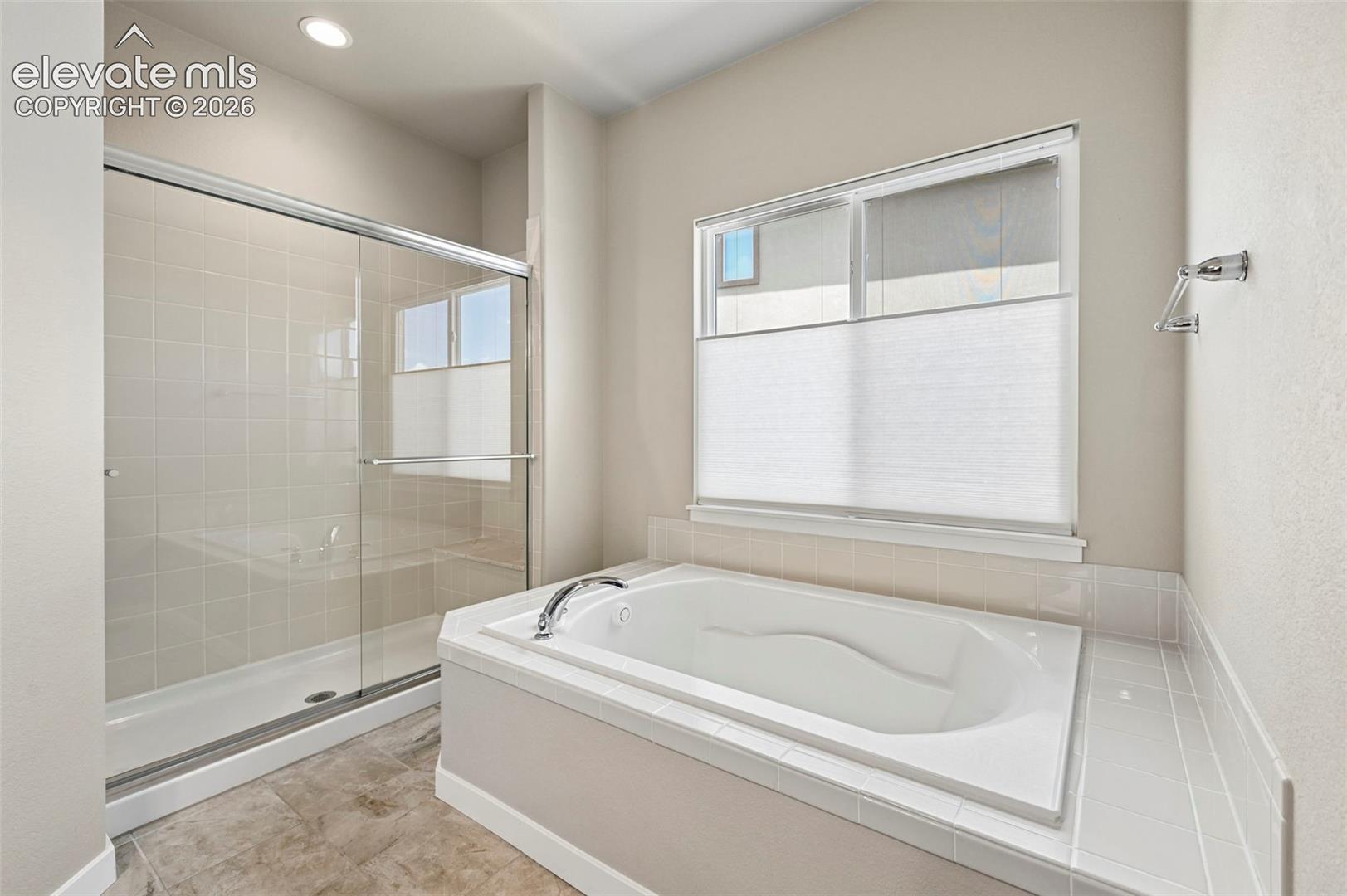 Primary Bathroom with tub and standing shower