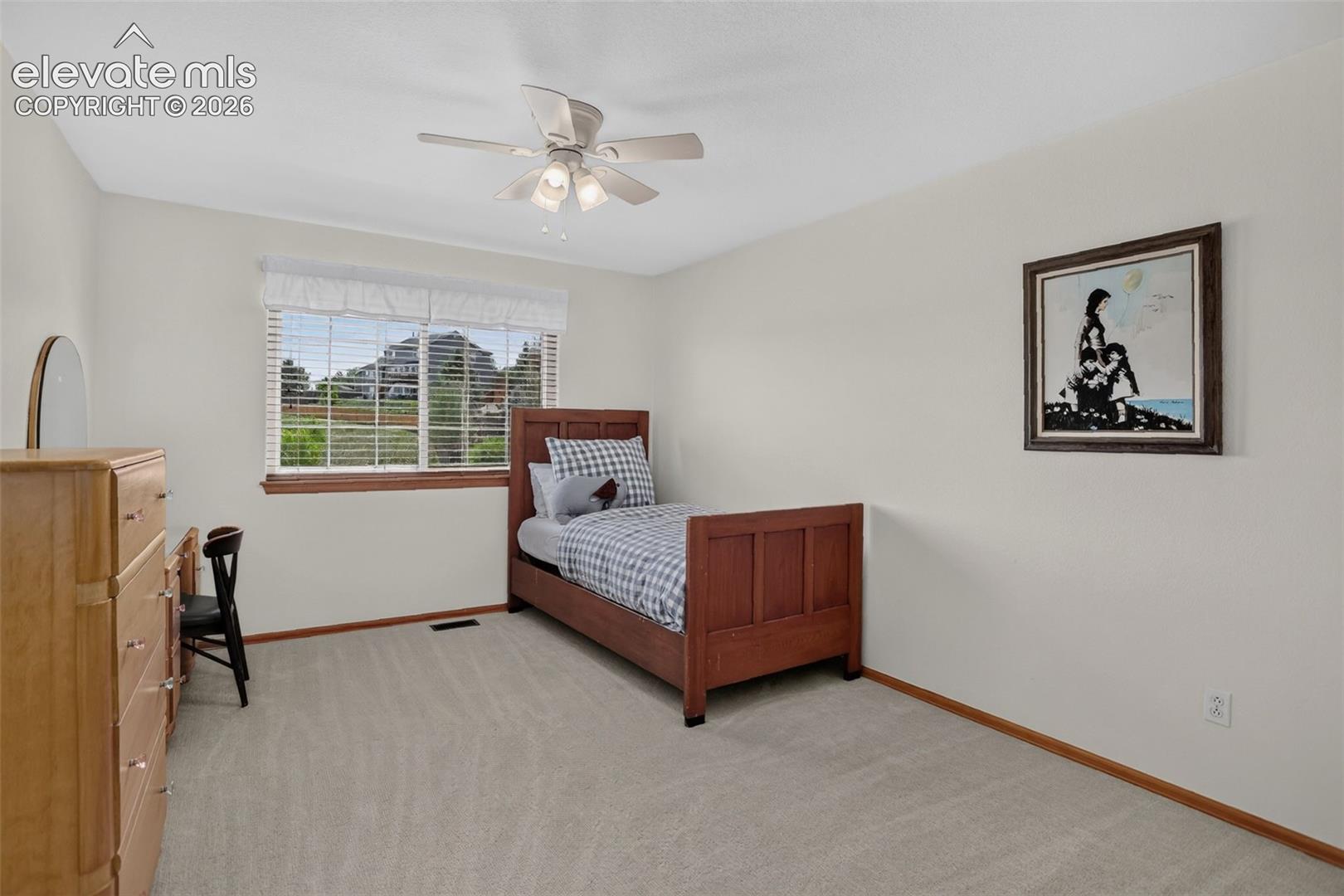 Bedroom featuring light-toned carpeting, a window with blinds, and a ceiling fan with integrated lighting