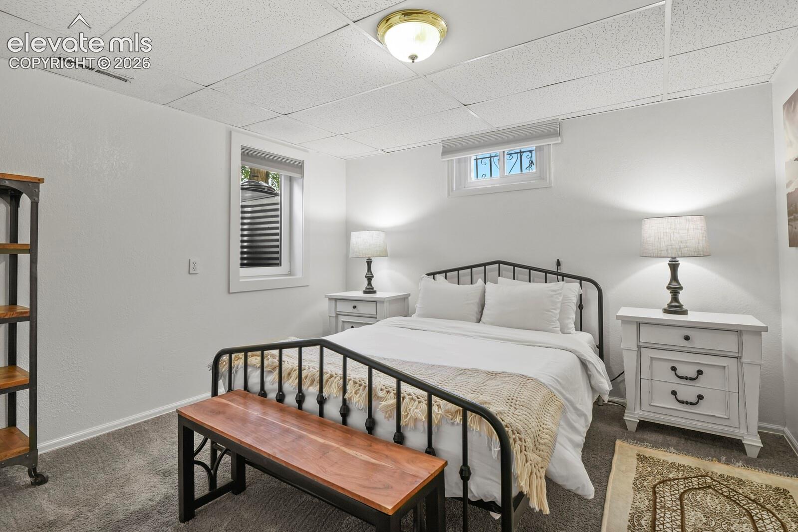 Basement bedroom with egress windows installed to code.