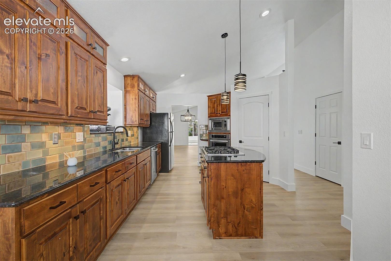 Kitchen with large center island and gas range
