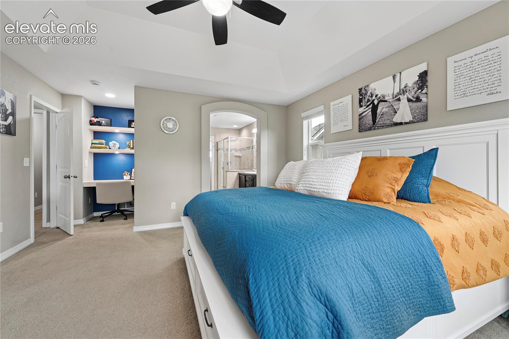 If you need desk space behind a closed door, this well-lit nook in the corner of the master is perfect, with its natural wood shelves & desk and ample lighting.  The en-suite bathroom upgrades are just beyond the archway.