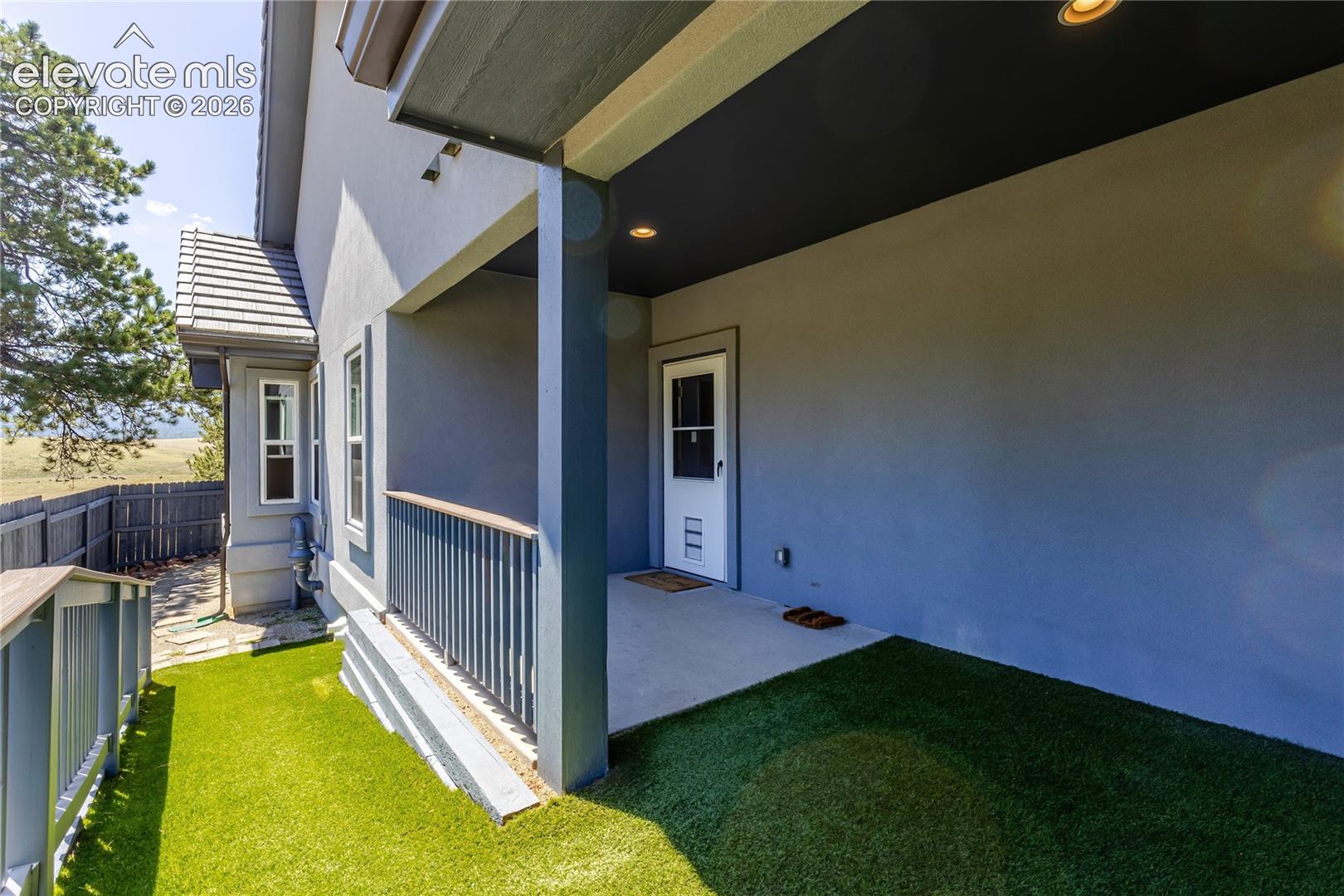 Side yard with door to laundry/mud room and dog wash. 