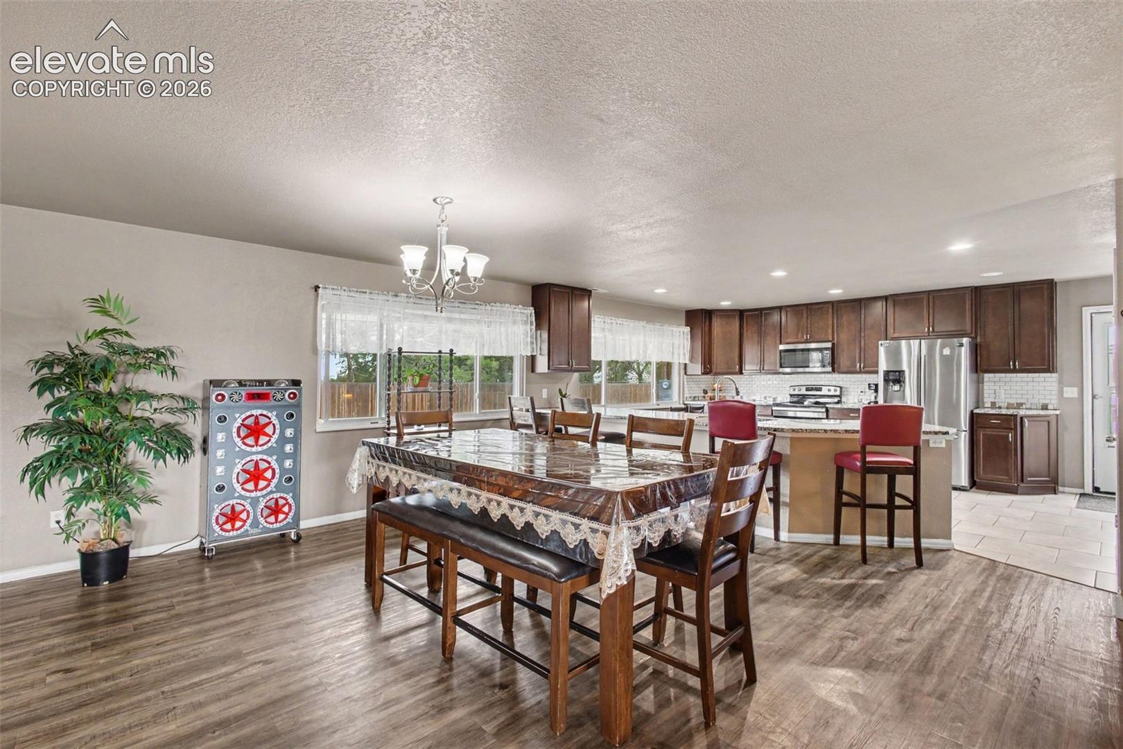 Open and inviting dining room centrally located in the home, providing a natural gathering space with easy flow to the surrounding living areas and kitchen.