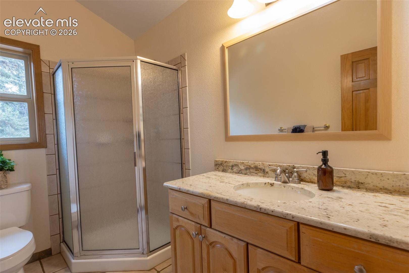 Wood-finish vanity with an integrated sink and light-colored countertop