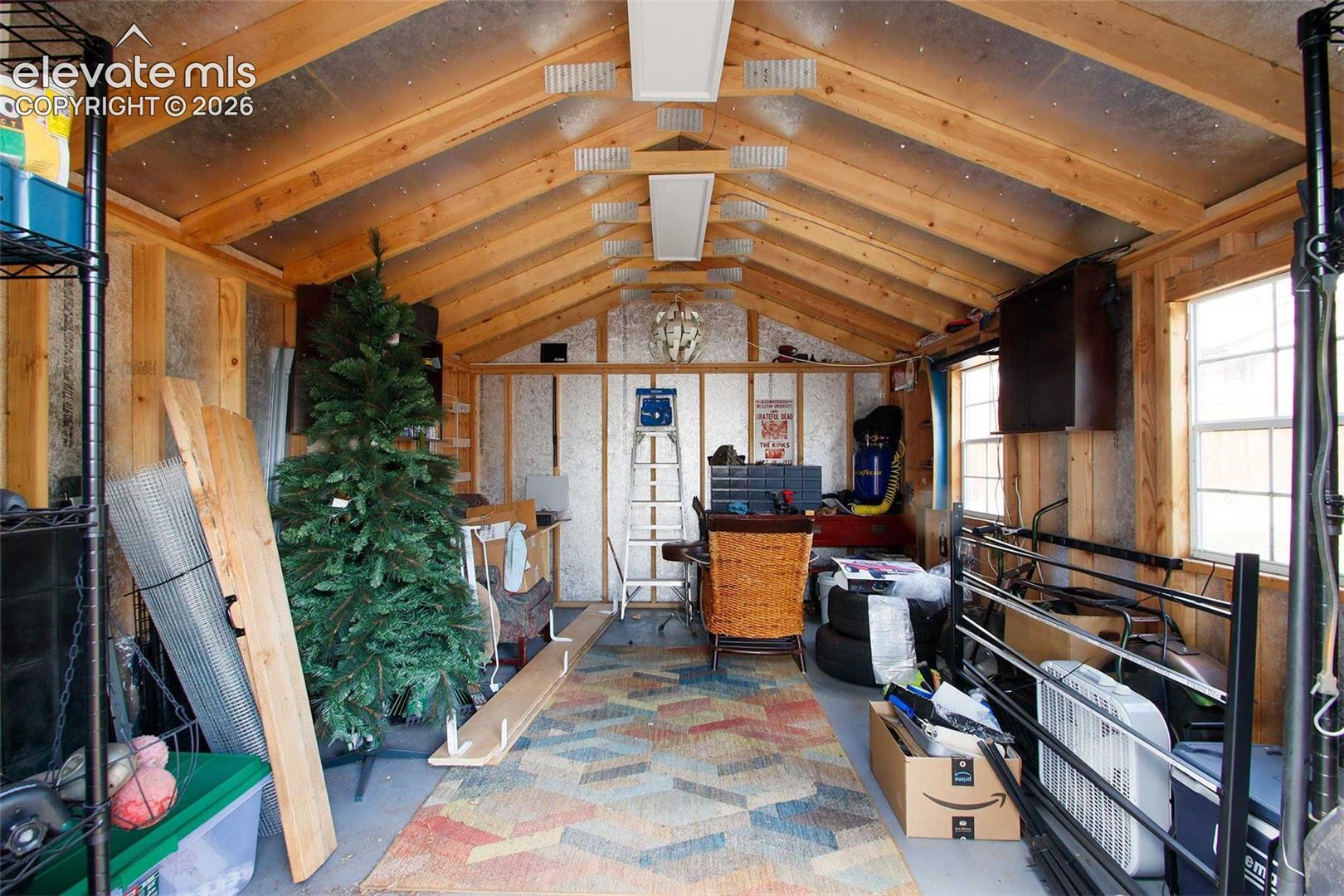 Vaulted wood-beam ceiling with exposed rafters and reflective insulation