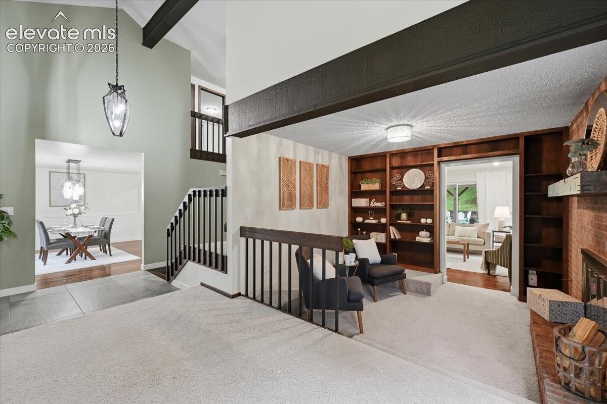 Living Room leads to Dedicated Den. Built ins and Gas Fireplace