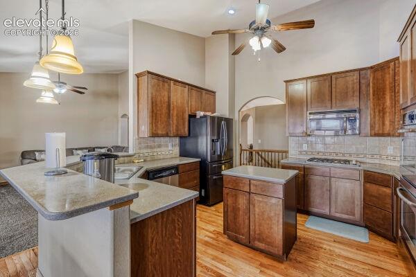 Kitchen featuring wood-finish flooring, recessed lighting, and a vaulted ceiling with a ceiling fan