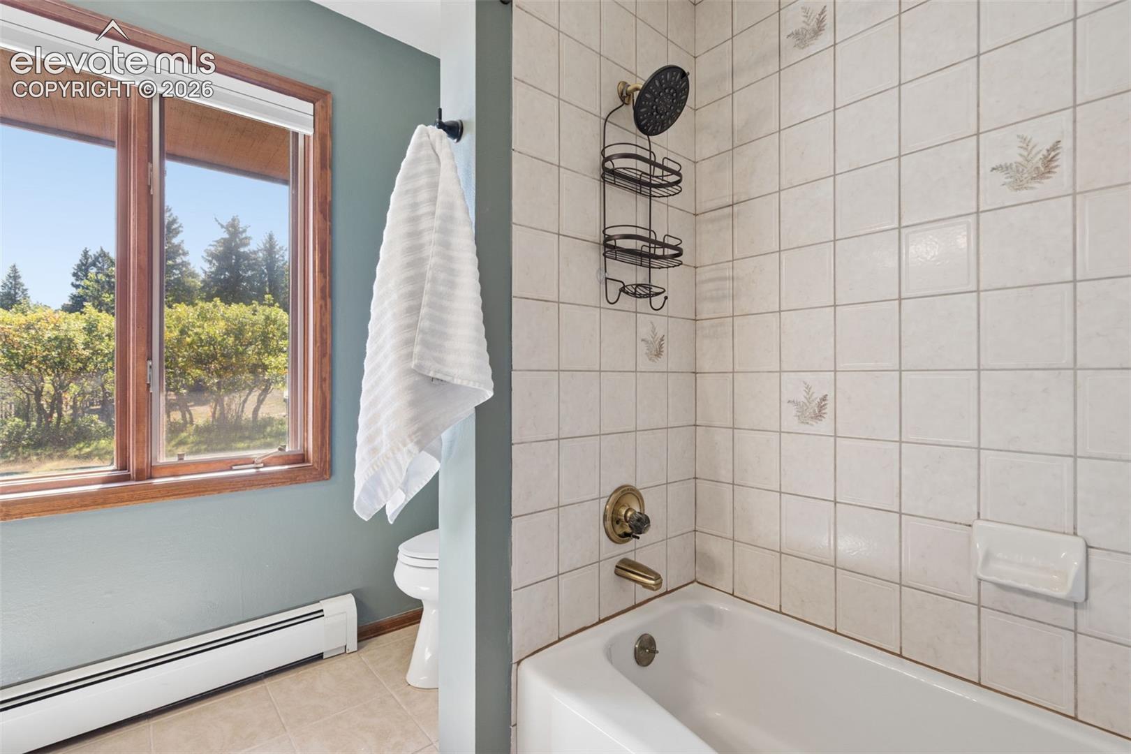 White tiled shower and tub combination