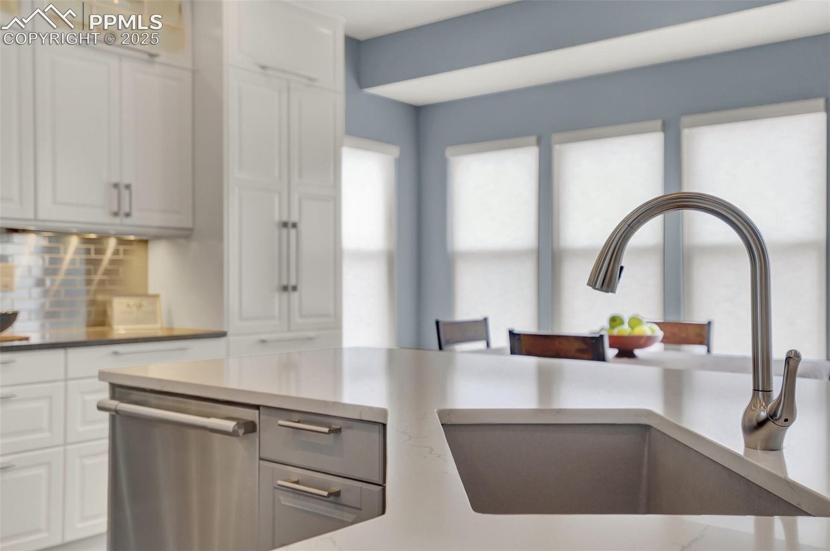 Custom granite farmhouse sink at the kitchen island