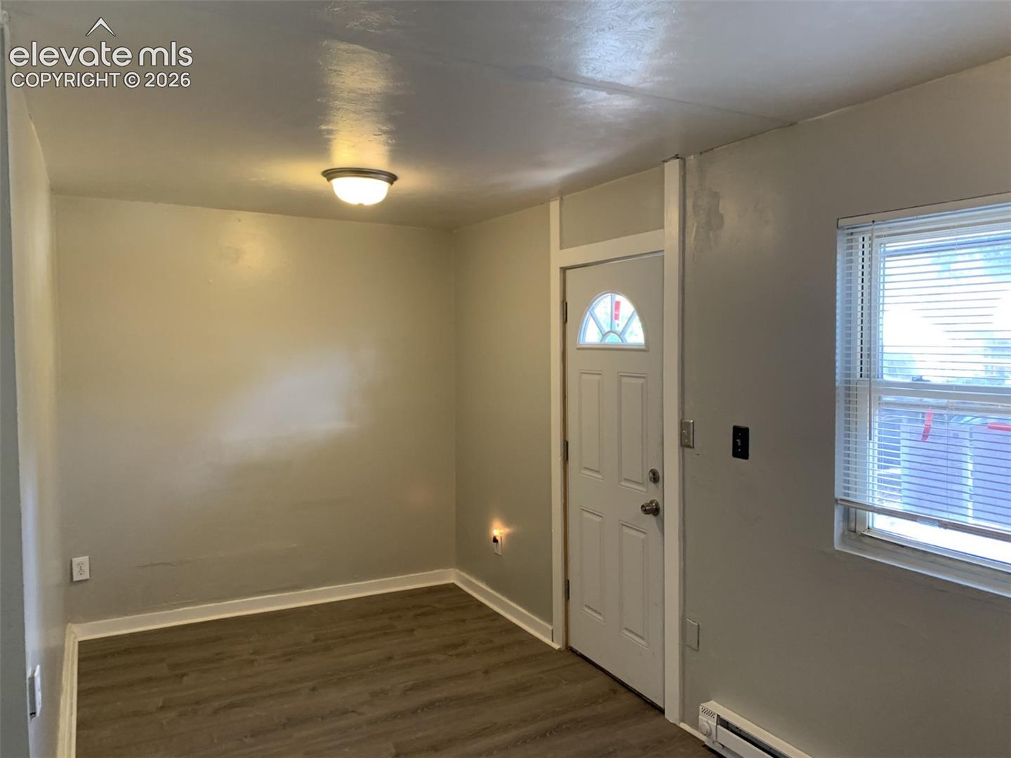APT 2  2 bed 1 full bath  
ceiling-mounted light fixture, white interior door with decorative glass insert, and window with blinds