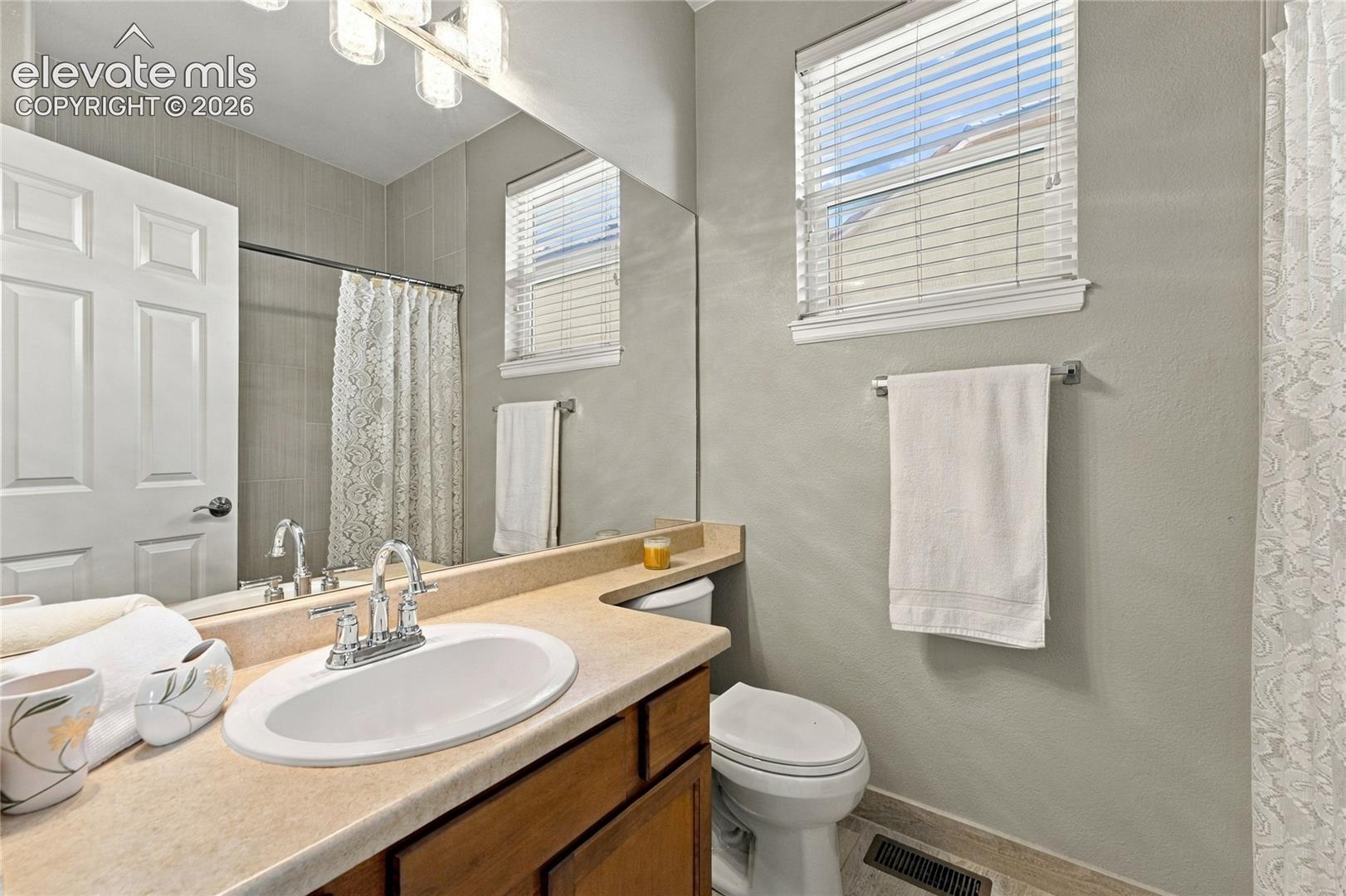 main level secondary bath with new lighting and bath hardware