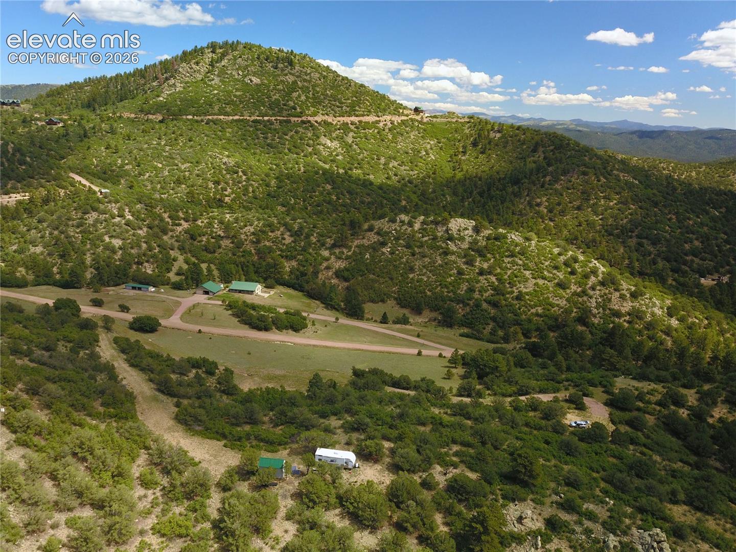 Lush, mountainous terrain with extensive tree coverage