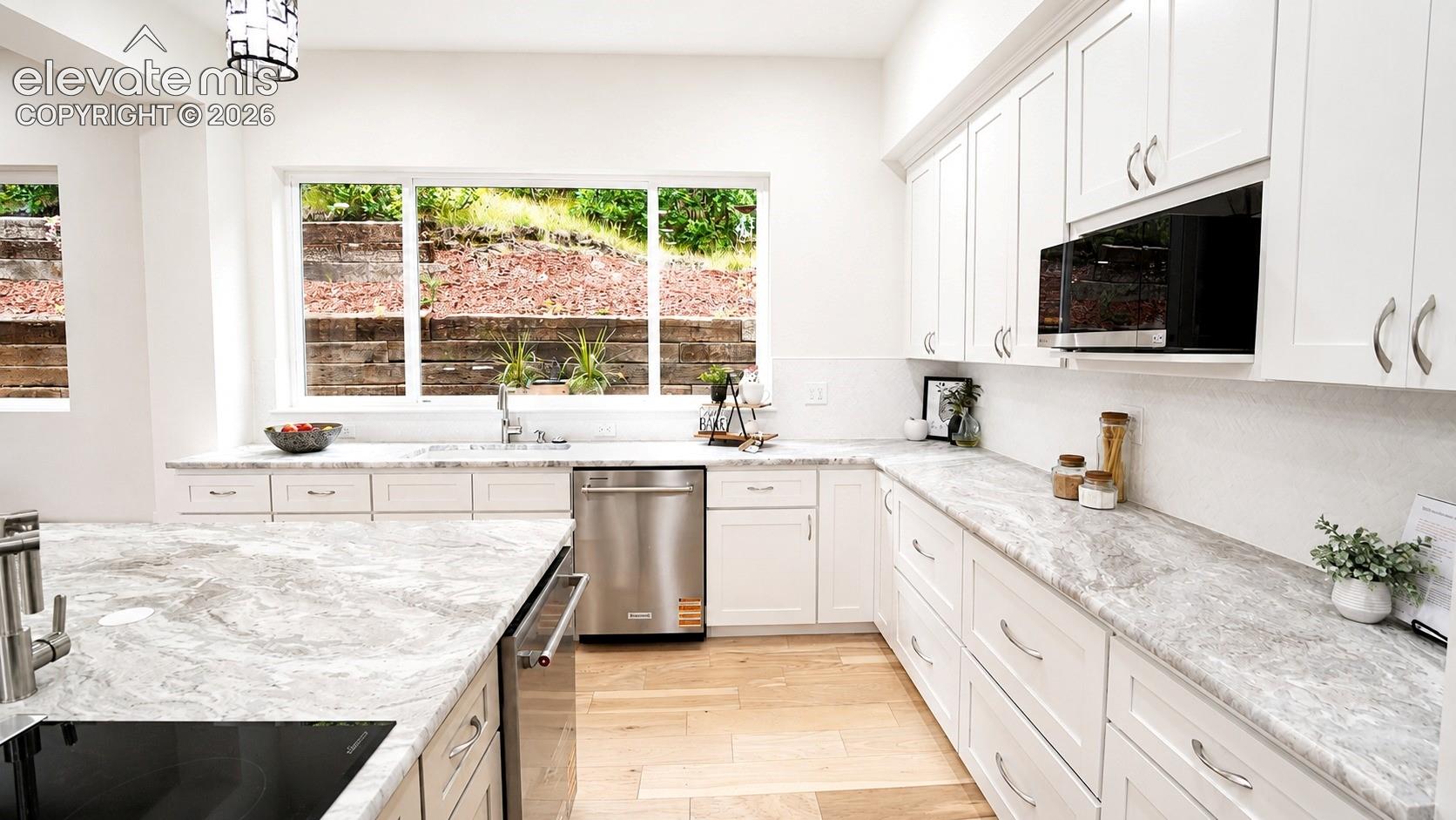 Beautiful leathered granite countertops in the Kitchen, 2 dishwashers, and pot filler at the cooktop. 