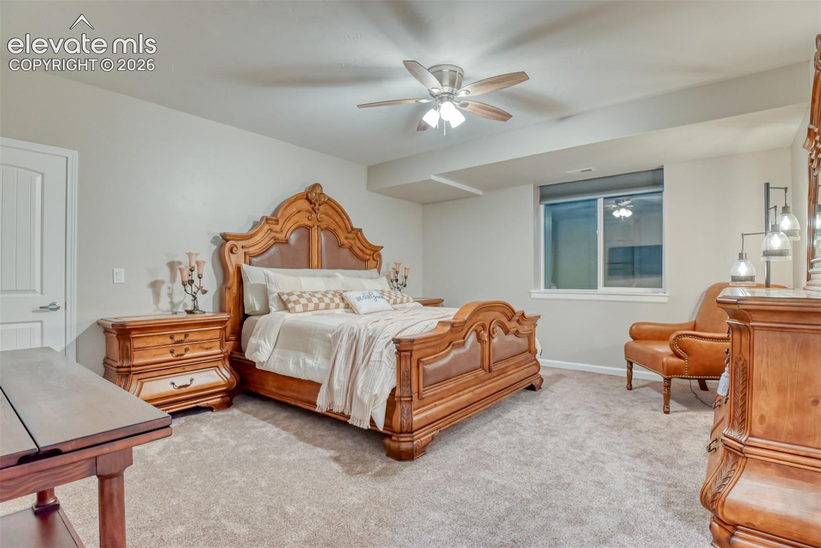 Carpeted room featuring a ceiling fan with integrated lighting.