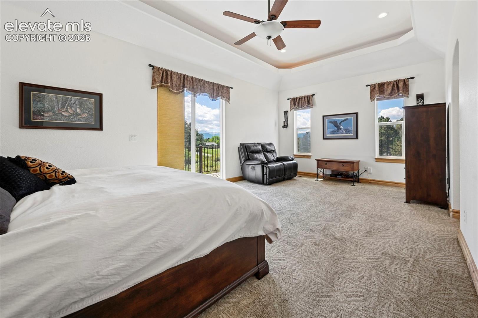 Primary suite, main level, tray ceiling with lighting and access to deck with mountain views!