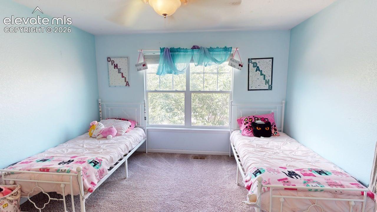 Carpeted flooring, central window, and ceiling light fixture