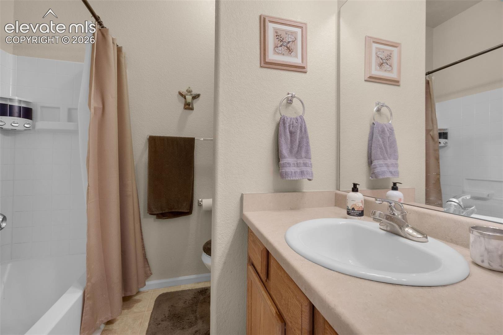 Bathroom vanity with an integrated sink, polished chrome faucet, and a large mirror