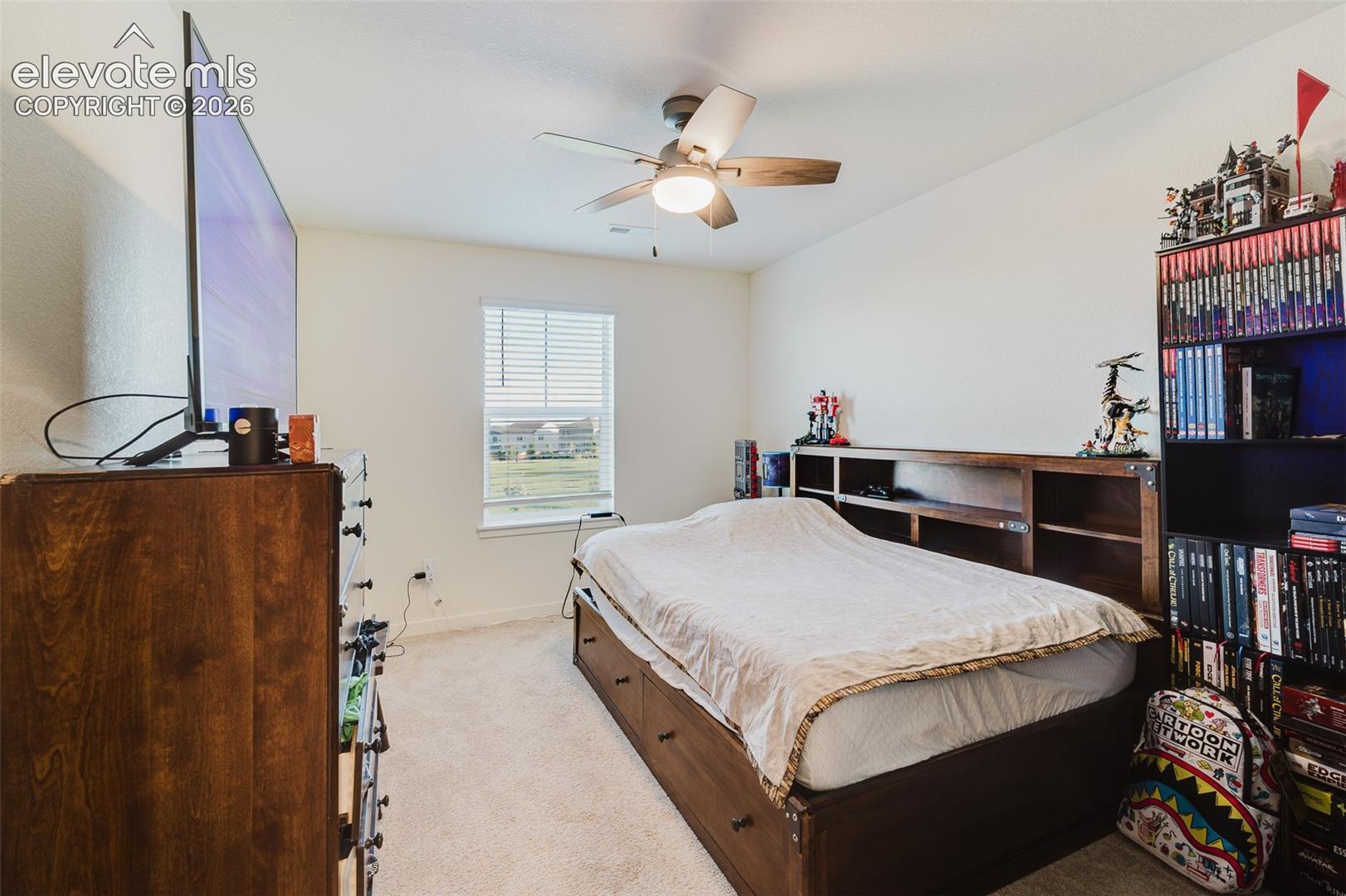 Upper Level Bedroom #3 with neutral carpet and a lighted ceiling fan.