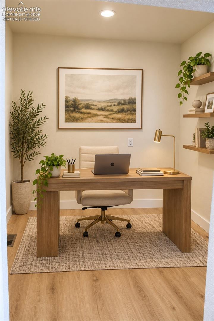 Virtually staged Wood-finish flooring, recessed ceiling lighting, built-in floating shelves, and a neutral wall color