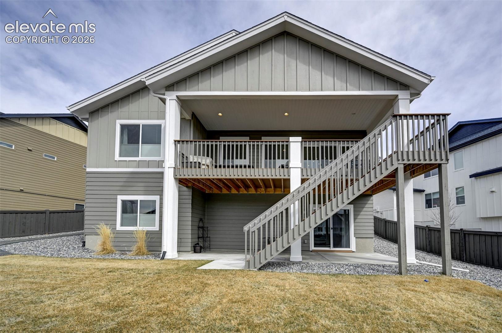 Two-story exterior with a covered upper deck and lower patio