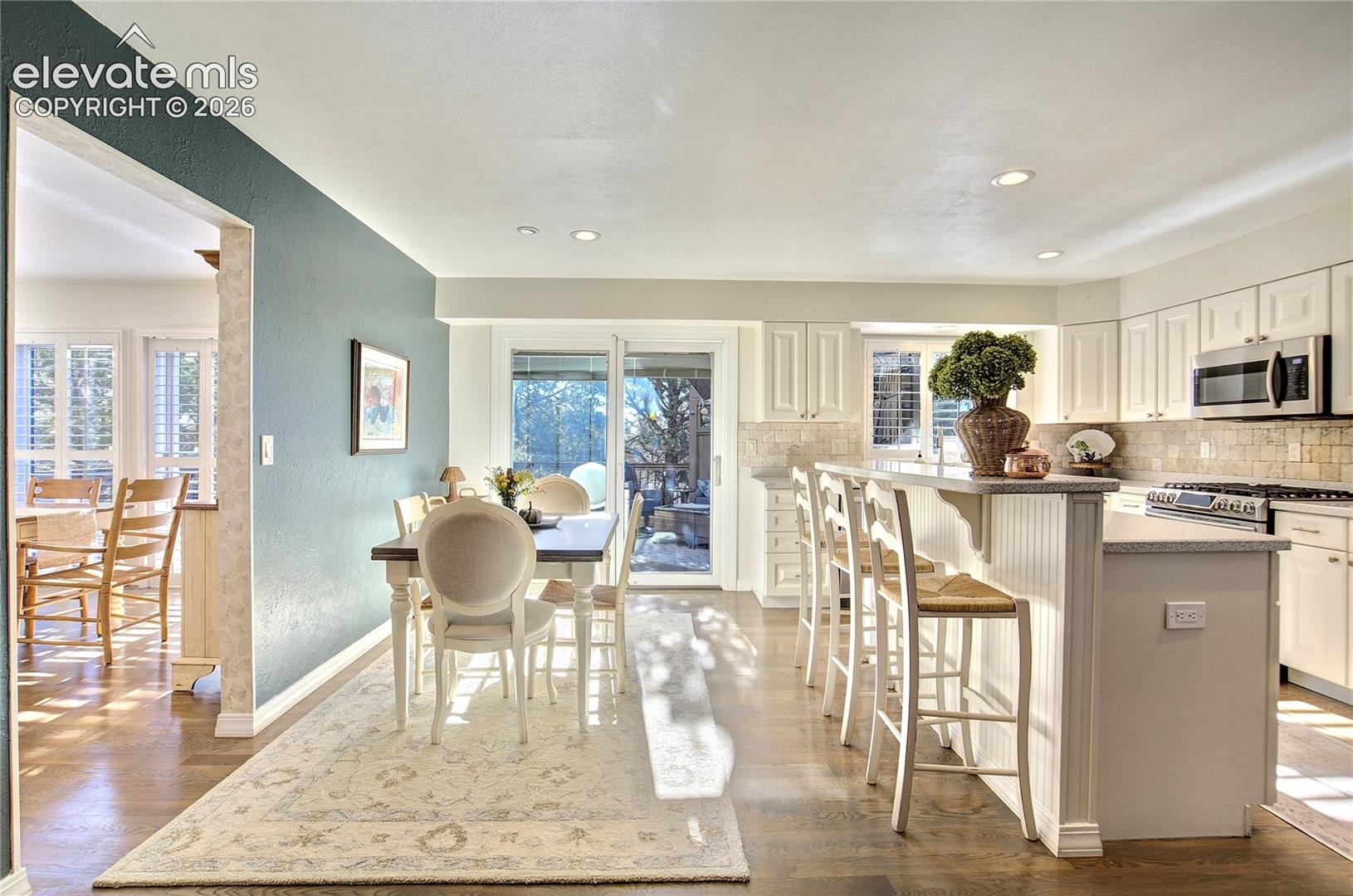 Natural light pours into the kitchen + breakfast nook, with the deck just beyond for seamless indoor-outdoor living.