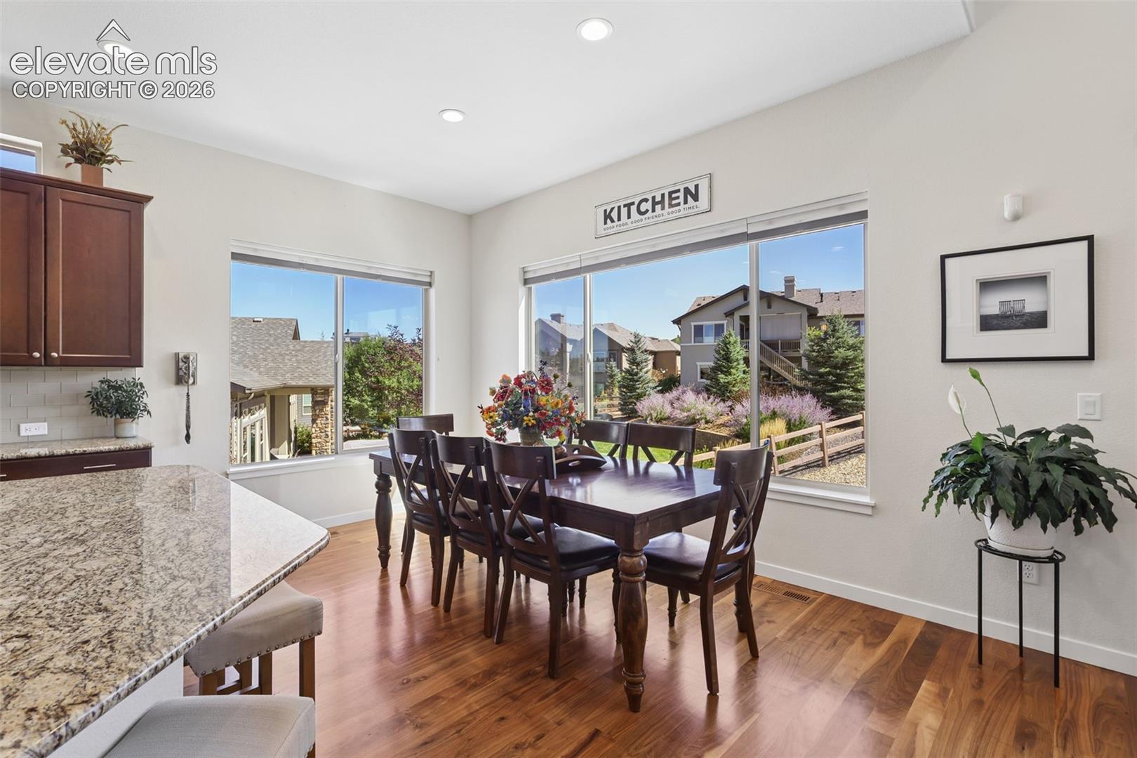 Wood-finish flooring, recessed lighting, and large windows
