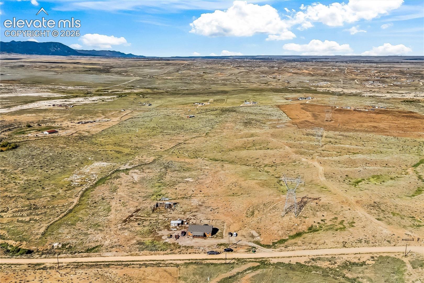 Expansive acreage featuring rugged terrain, mountain topography, and direct access to an unpaved road
