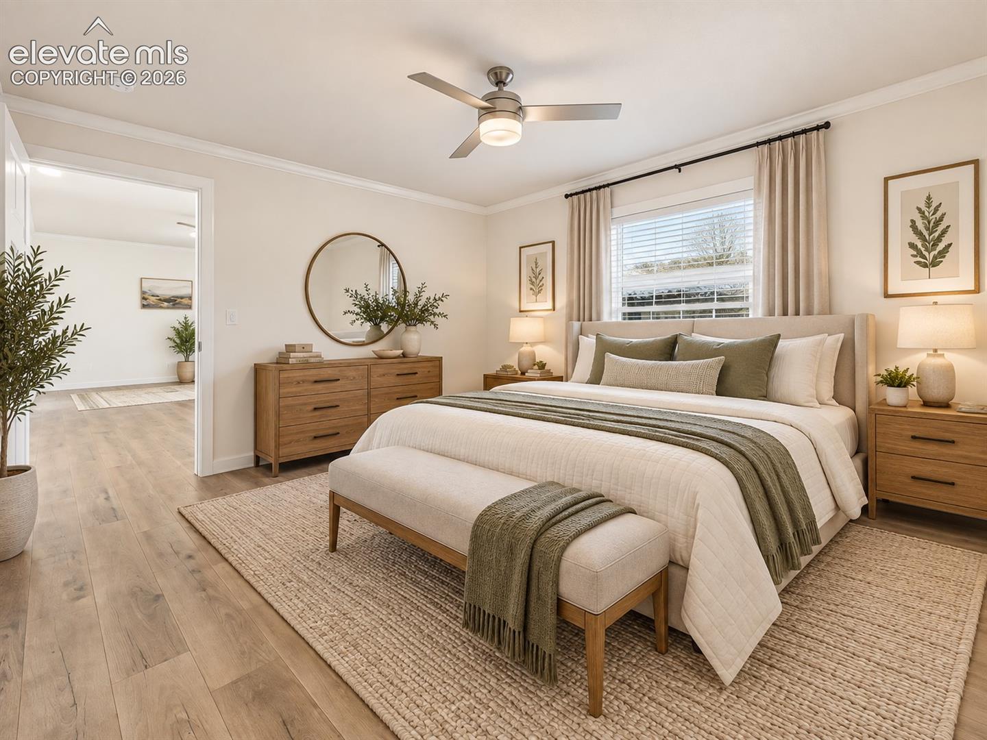 Primary Bedroom – Generously sized primary bedroom offers wide-plank flooring, a ceiling fan, abundant natural light, and plenty of space for a complete bedroom suite.