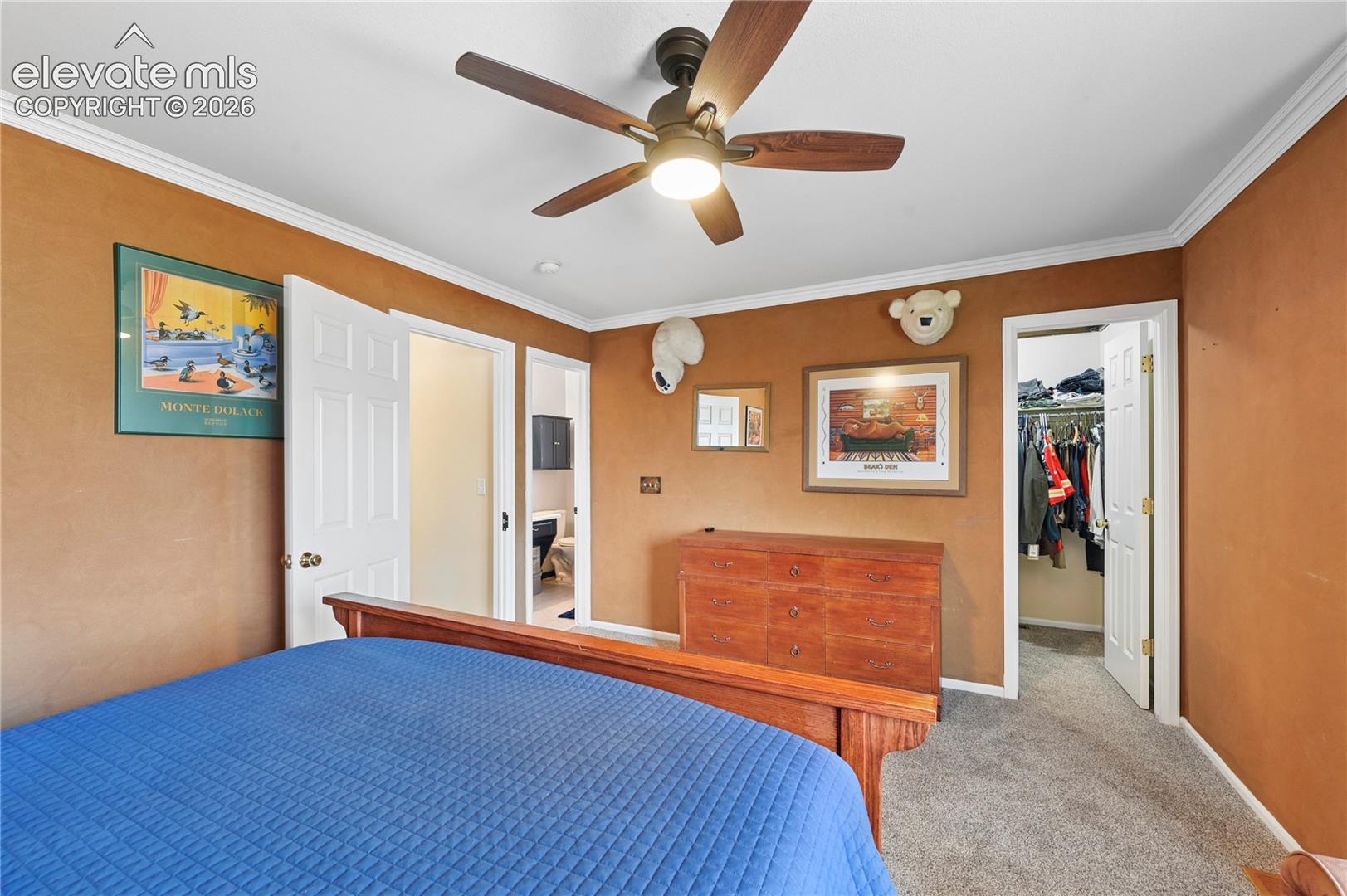 Primary bedroom upstairs with walk-in closet and en-suite bathroom