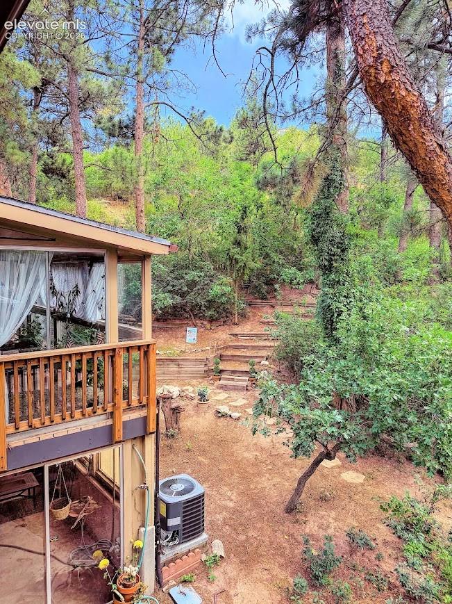 Tiered backyard with natural landscaping and mature trees