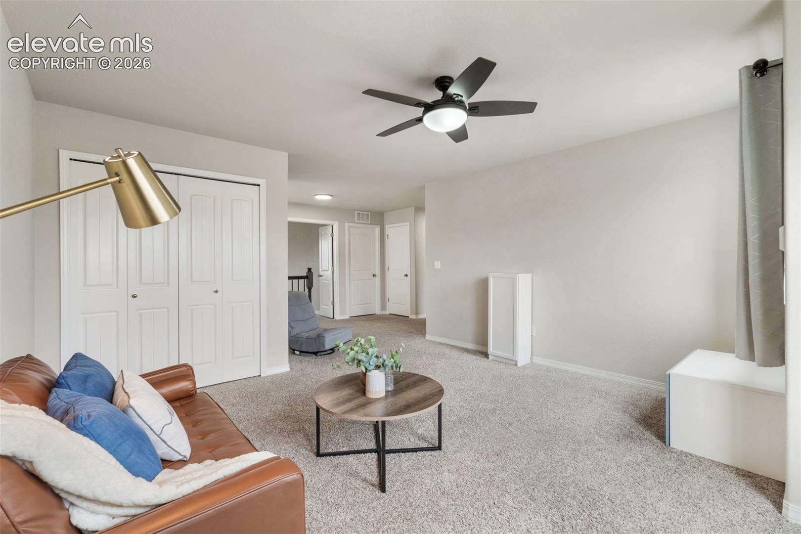 Recessed lighting, ceiling fan with integrated light, light-toned wall paint, neutral carpet flooring, and white bi-fold closet doors