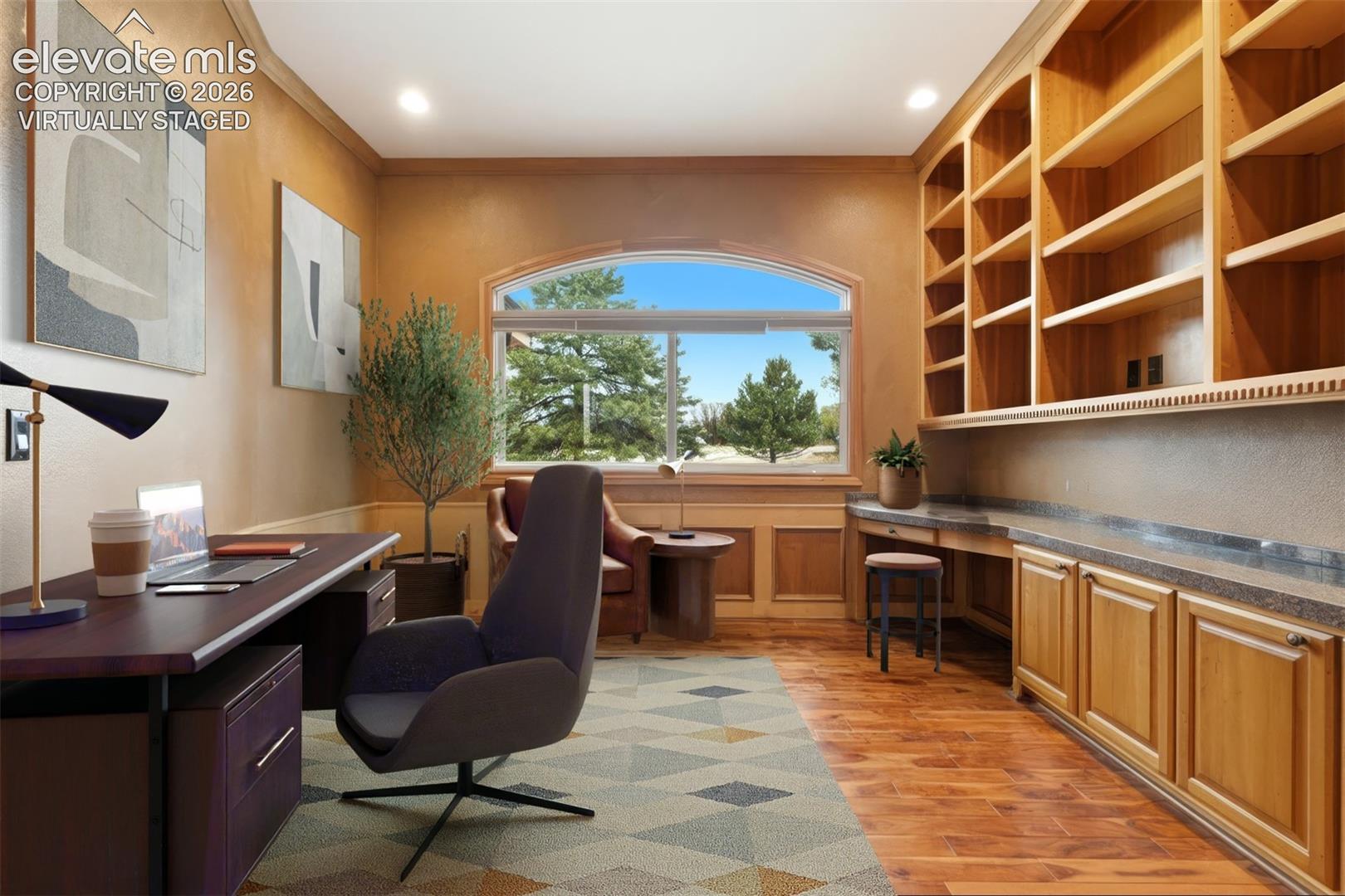 Virtually staged. Built-in wood shelving and cabinetry, arched window, wood-finish flooring, recessed lighting