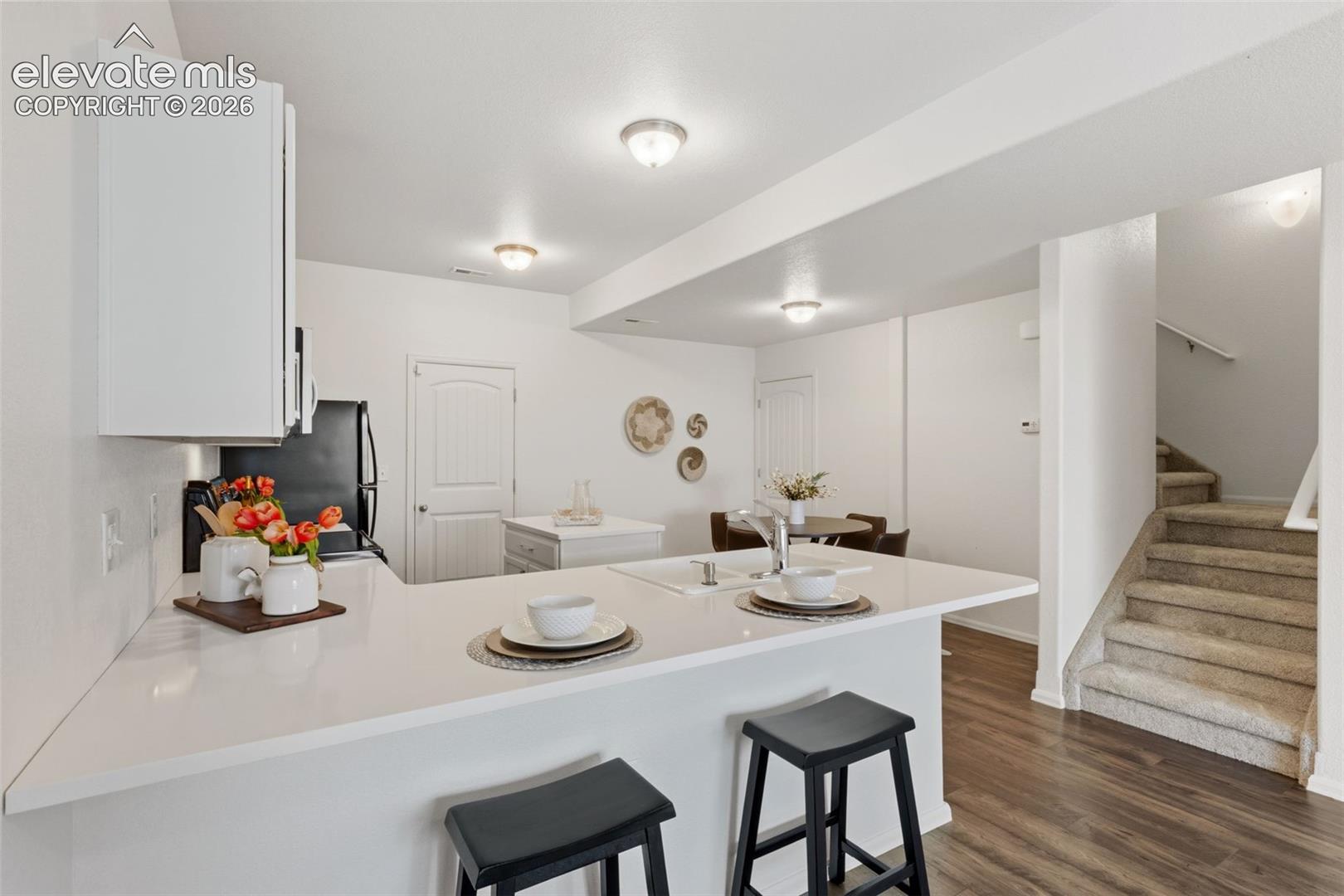 A large center breakfast bar island anchors the kitchen, providing an ideal spot for your morning coffee or casual dining