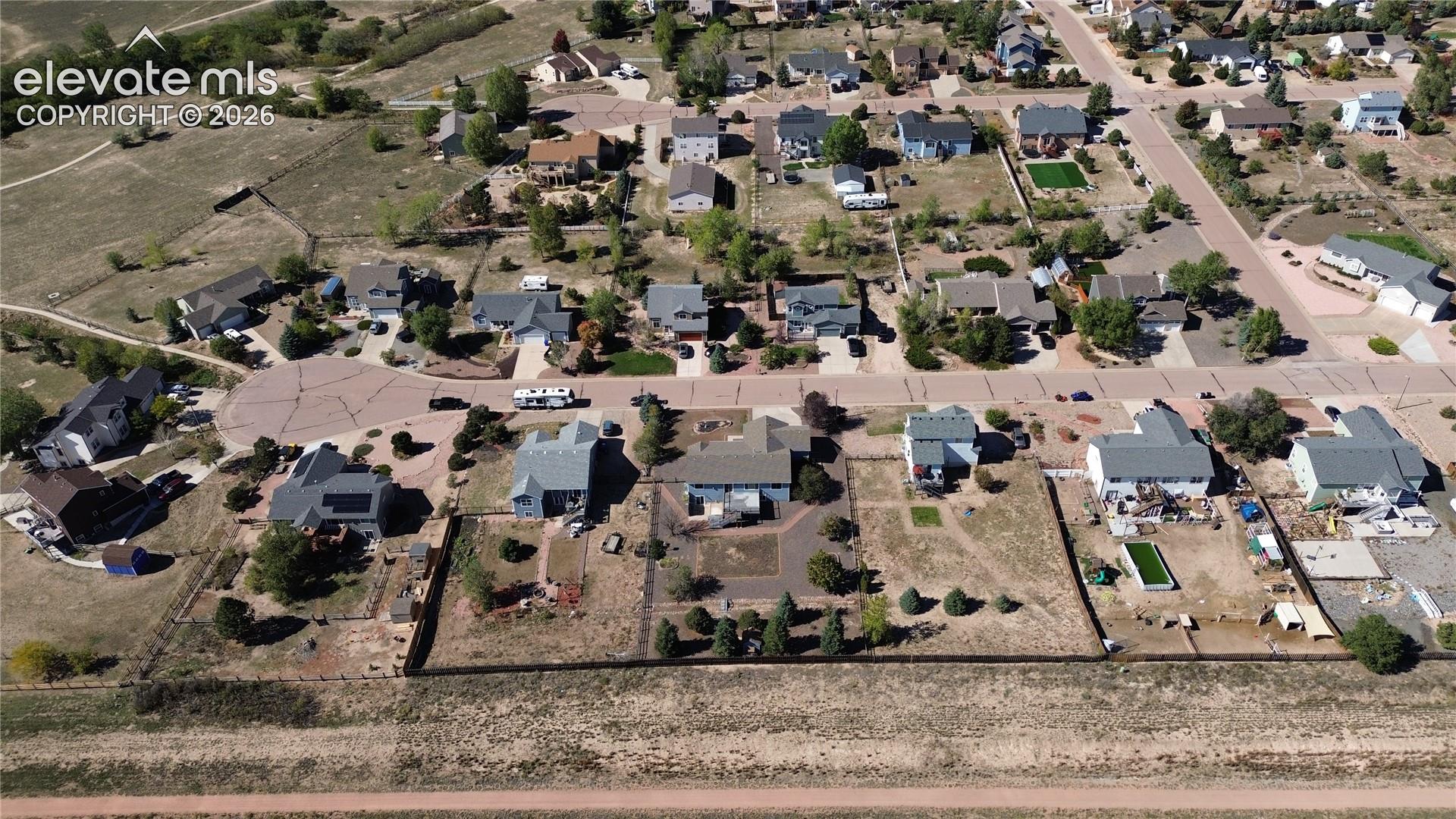 Aerial view of home and neighborhood.