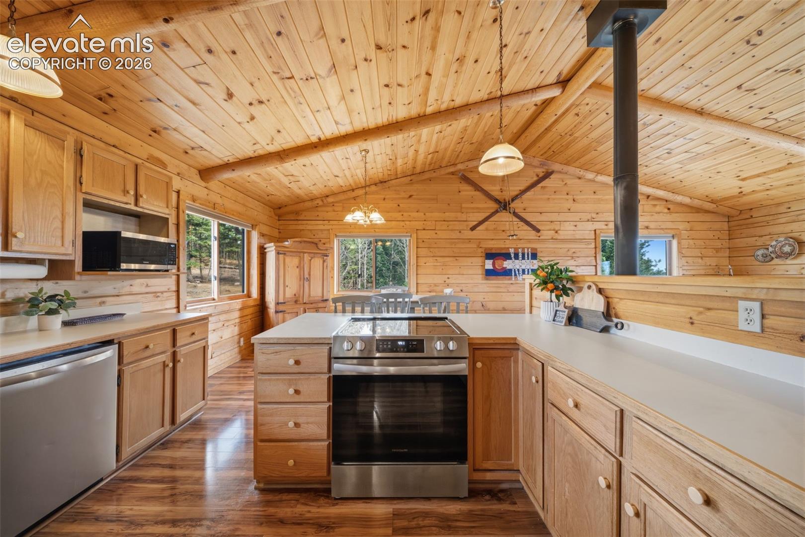 Main level kitchen with tongue and groove ceilings and beams