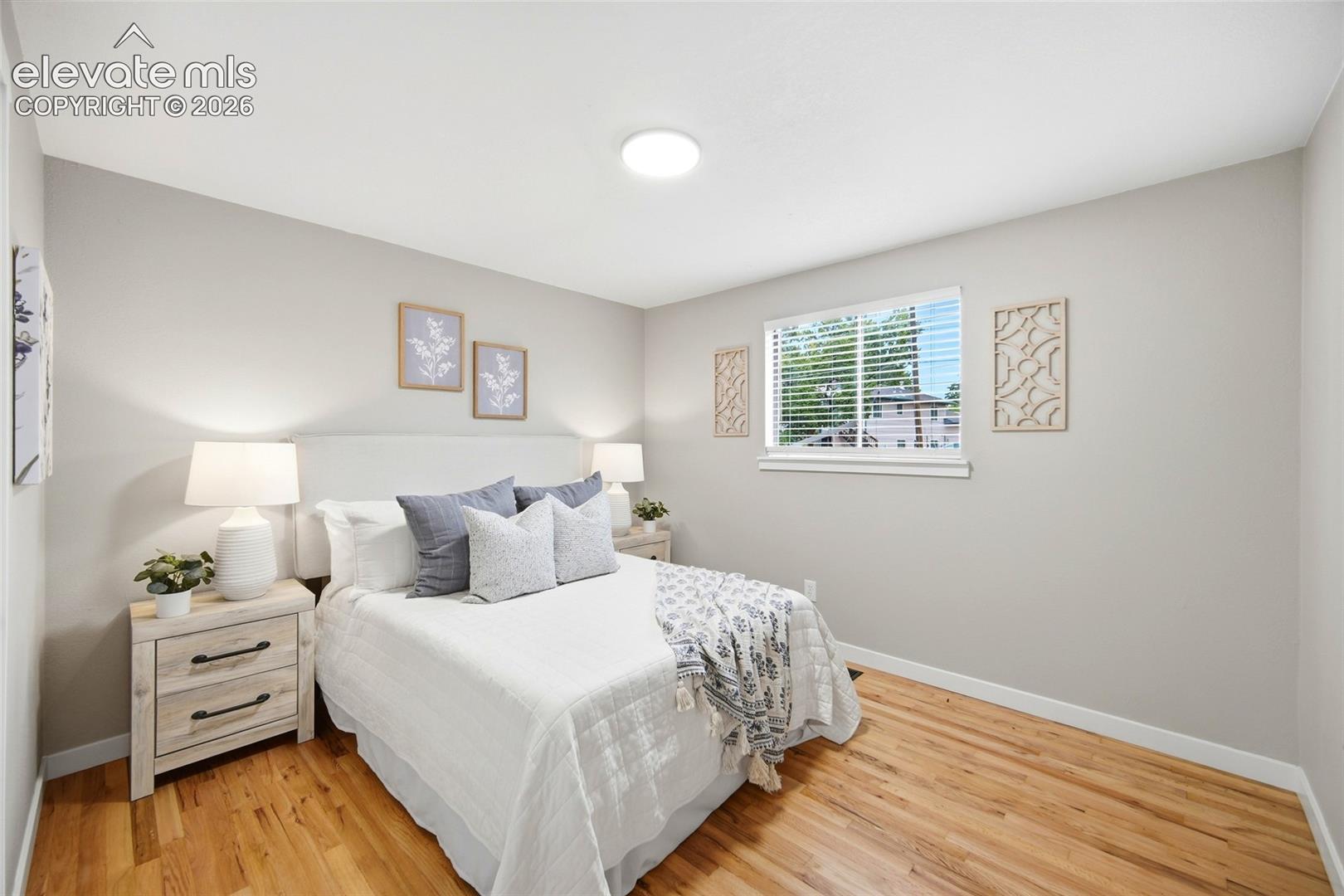 Hardwood-style flooring with a window offering natural illumination
