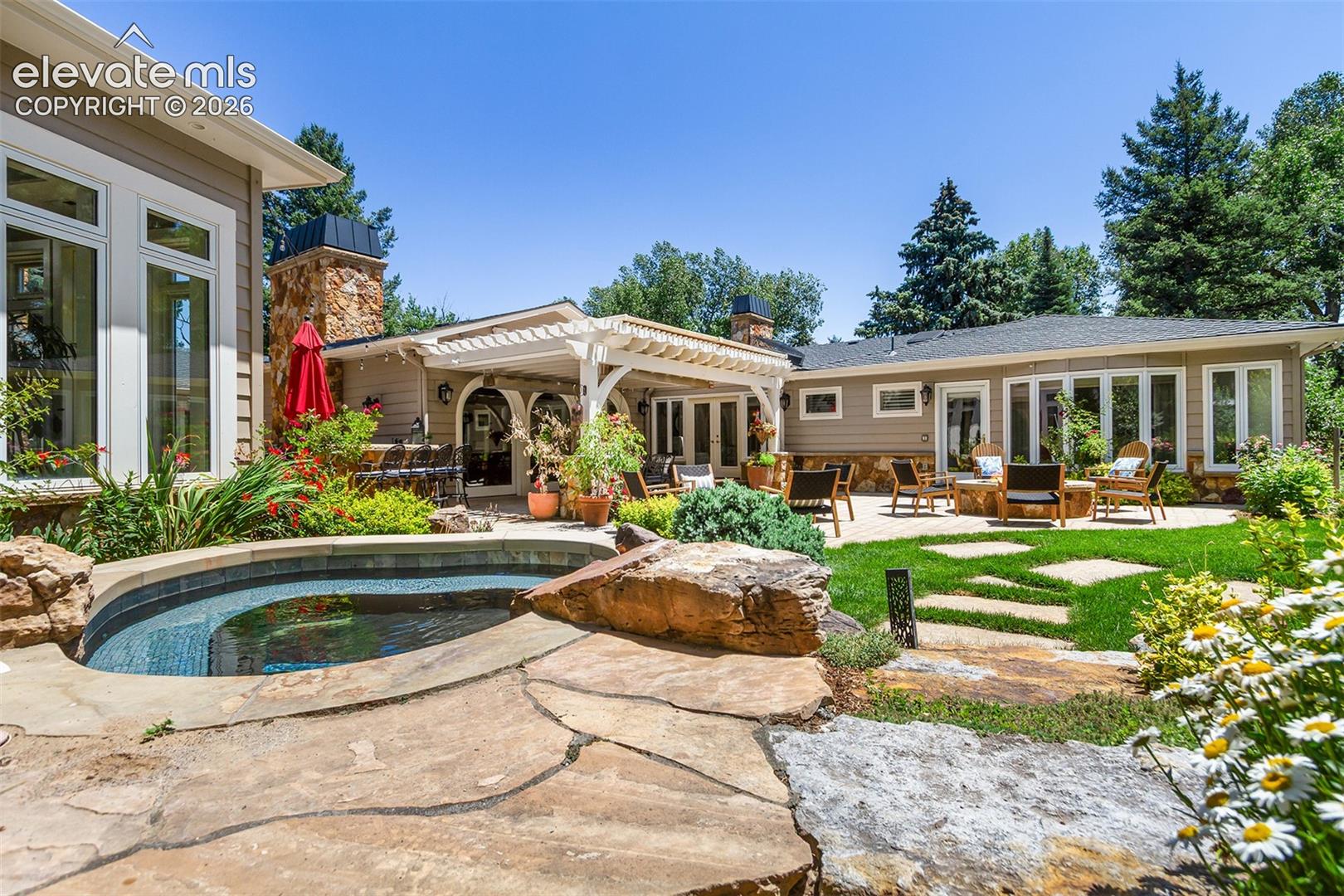 Hot tub, gas fire pit, waterfall feature, and grilling area.