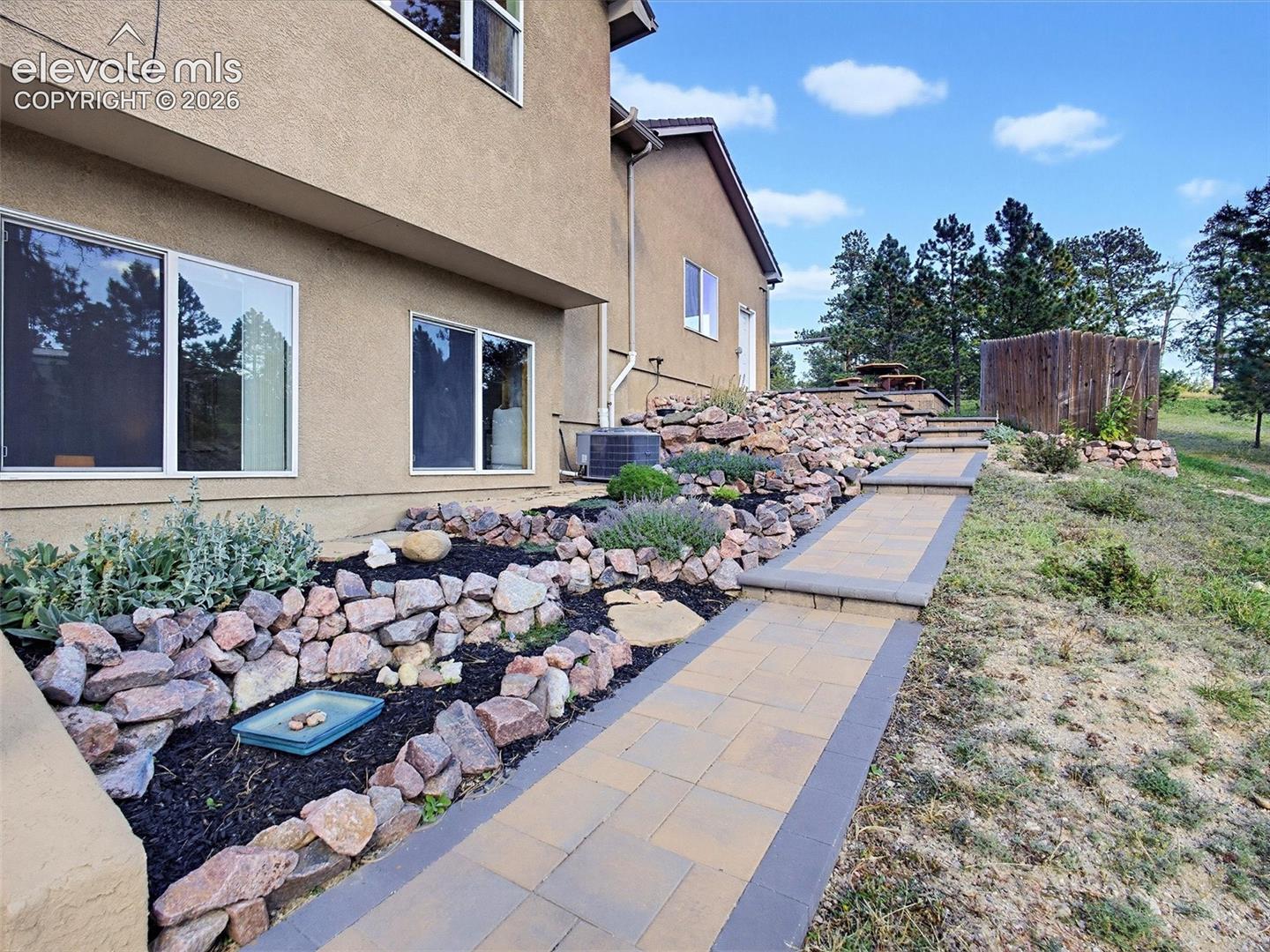 Lovely rock garden with perennials on side yard
